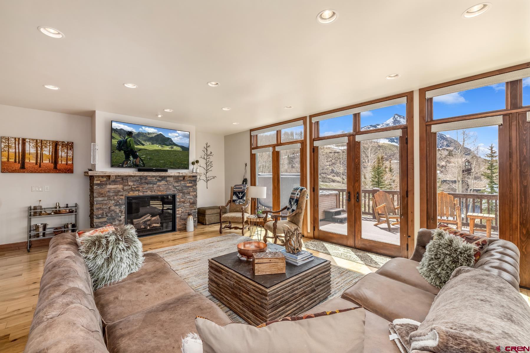 32 Cinnamon Mountain Road Crested Butte, CO 81225 - Photo 4 of 44 a living room with fireplace furniture and a flat screen tv