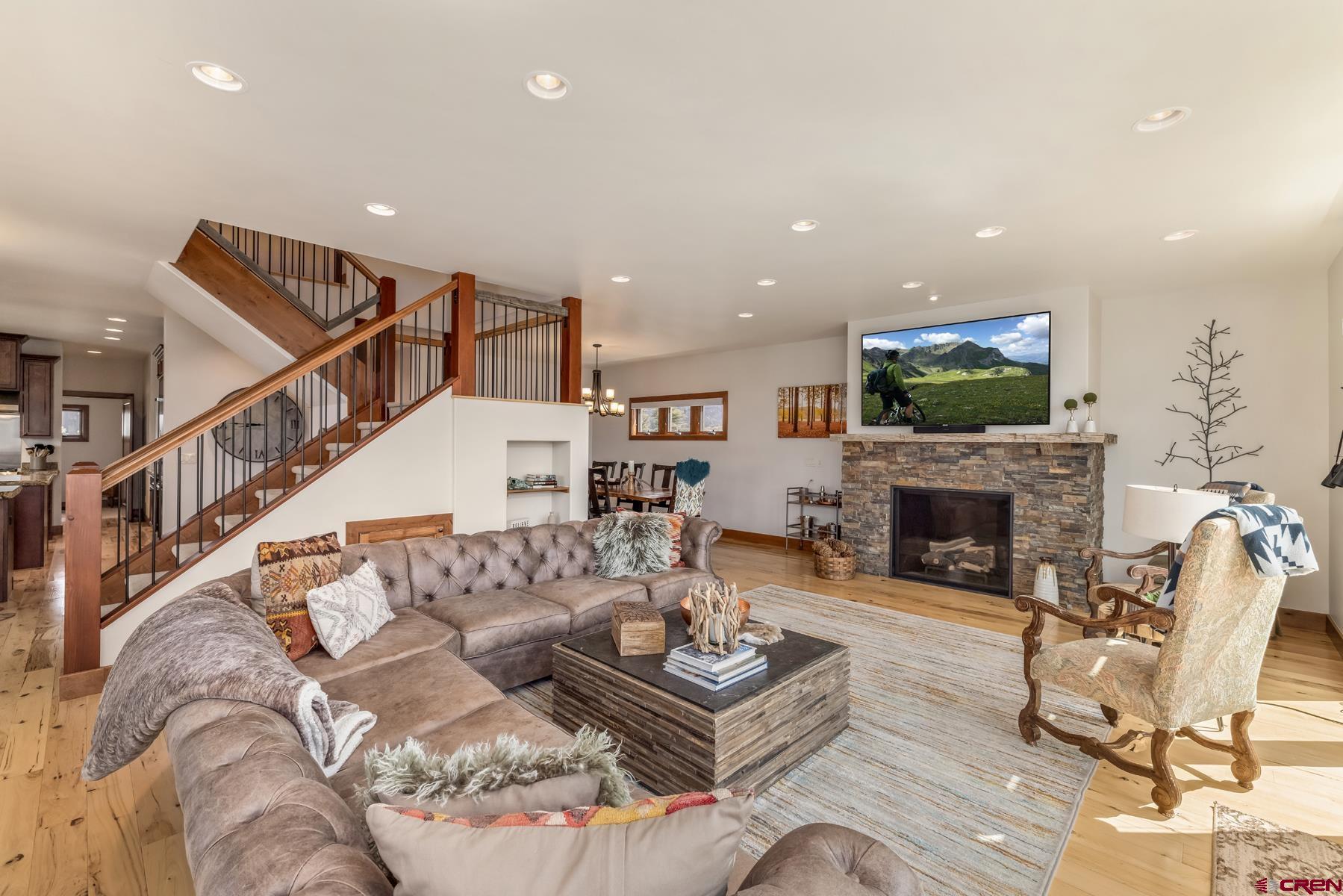 32 Cinnamon Mountain Road Crested Butte, CO 81225 - Photo 5 of 44 a living room with furniture a fireplace and a flat screen tv