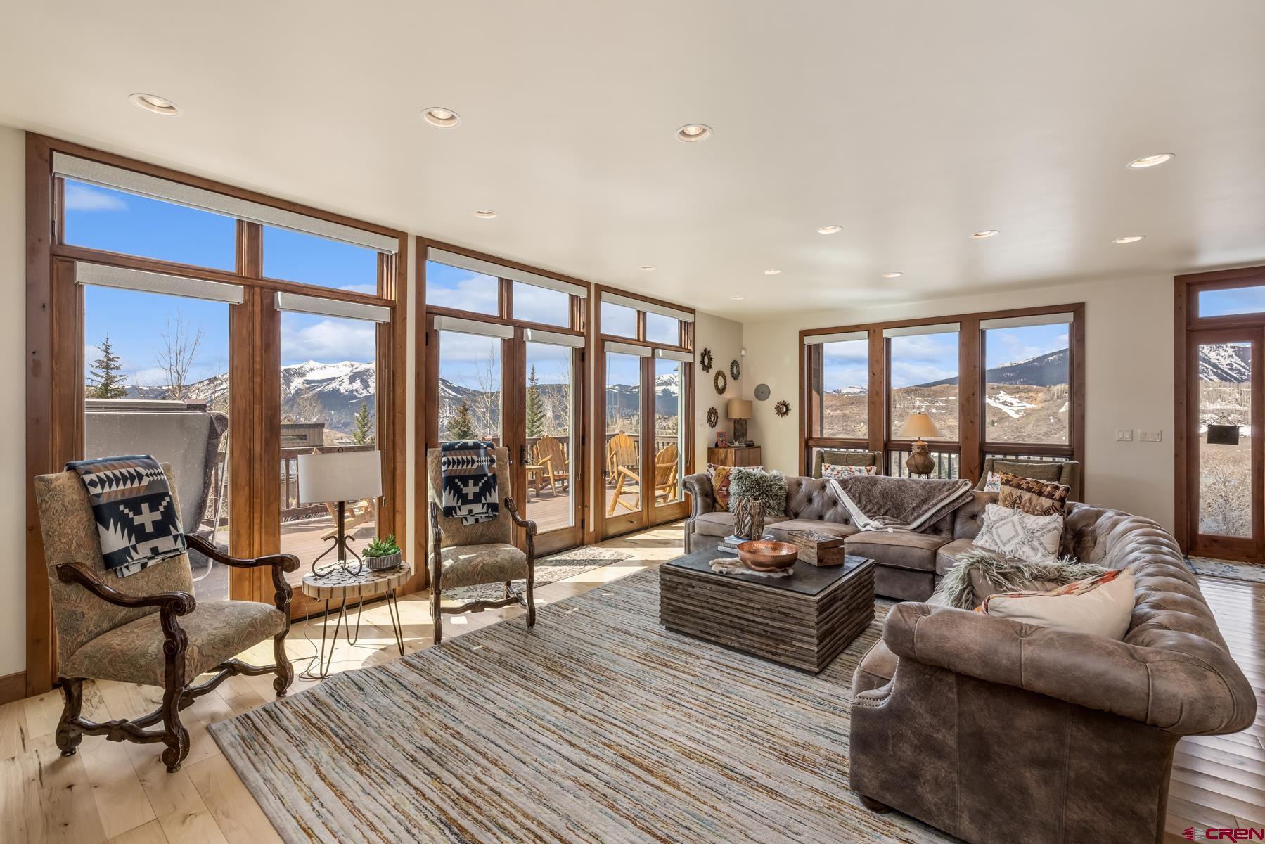 32 Cinnamon Mountain Road Crested Butte, CO 81225 - Photo 6 of 44 a living room with furniture and floor to ceiling windows