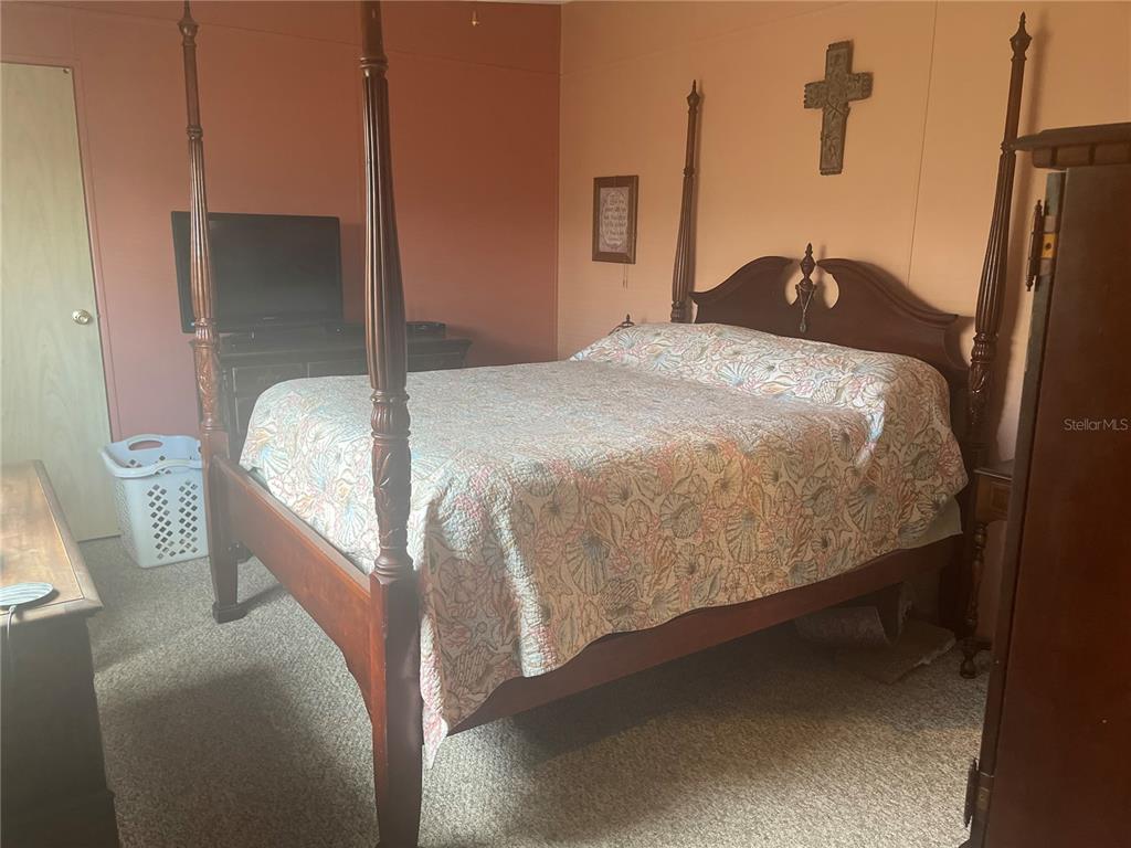 4179 Rolling Oaks Drive Winter Haven, FL 33880 - Photo 13 of 31 a bedroom with a bed and a mirror