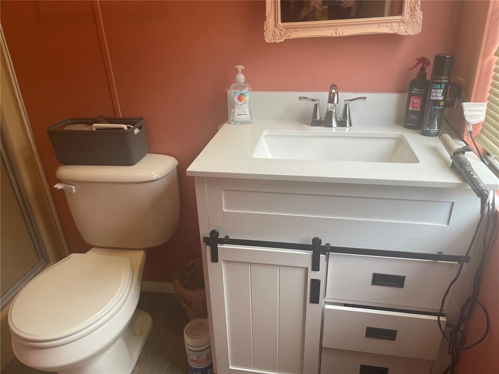 4179 Rolling Oaks Drive Winter Haven, FL 33880 - Photo 14 of 31 a white toilet sitting next to a bathroom sink