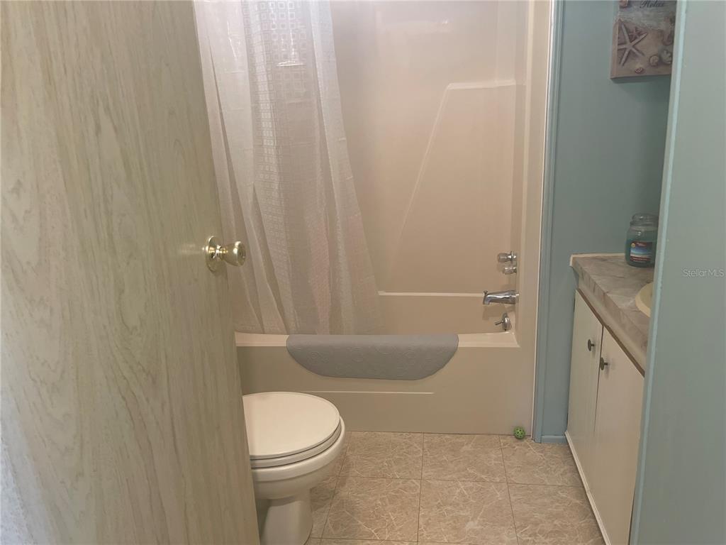 4179 Rolling Oaks Drive Winter Haven, FL 33880 - Photo 17 of 31 a bathroom with a toilet a sink and bathtub