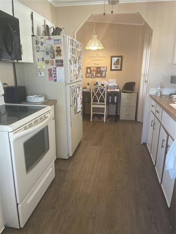4179 Rolling Oaks Drive Winter Haven, FL 33880 - Photo 18 of 31 a kitchen with stainless steel appliances a stove a sink and a refrigerator