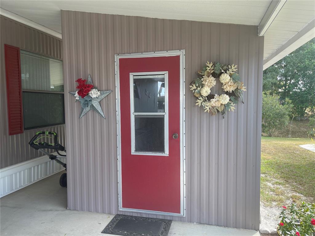 4179 Rolling Oaks Drive Winter Haven, FL 33880 - Photo 3 of 31 a front view of a house with a porch