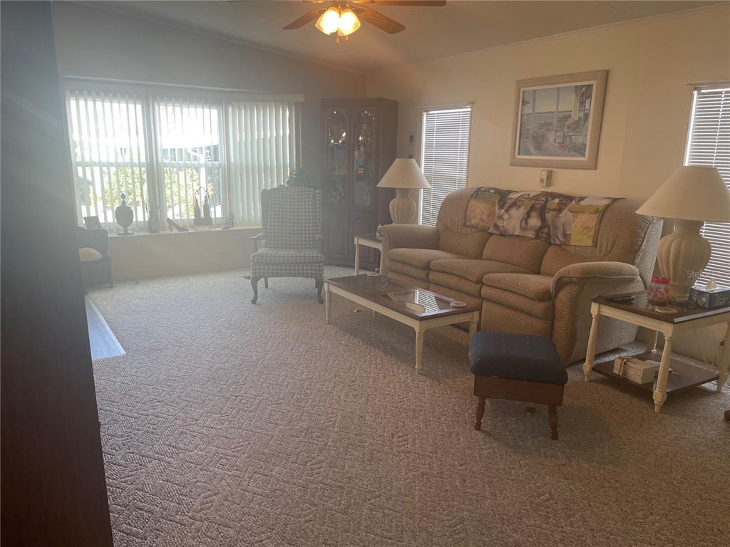 4179 Rolling Oaks Drive Winter Haven, FL 33880 - Photo 10 of 31 a living room with furniture and a window