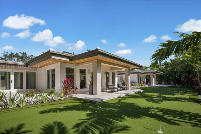 a front view of house with yard and green space