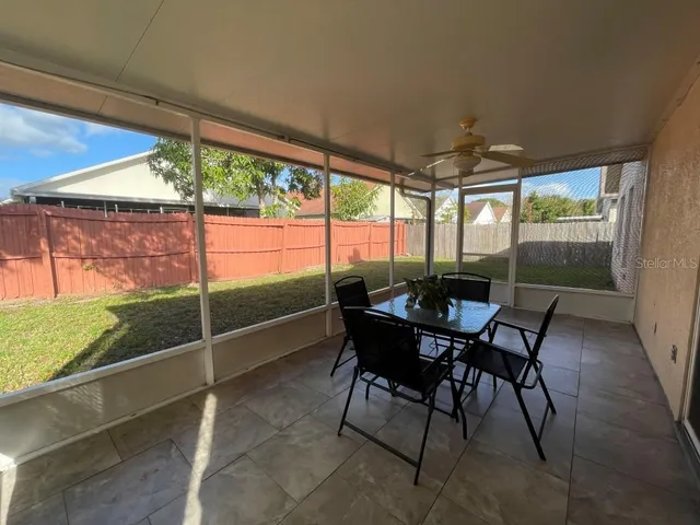 a view of a porch with furniture and wooden floor