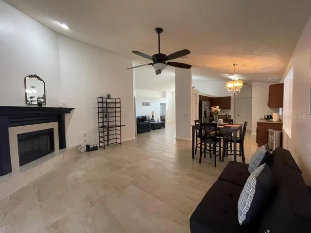 a view of a livingroom with furniture and a ceiling fan