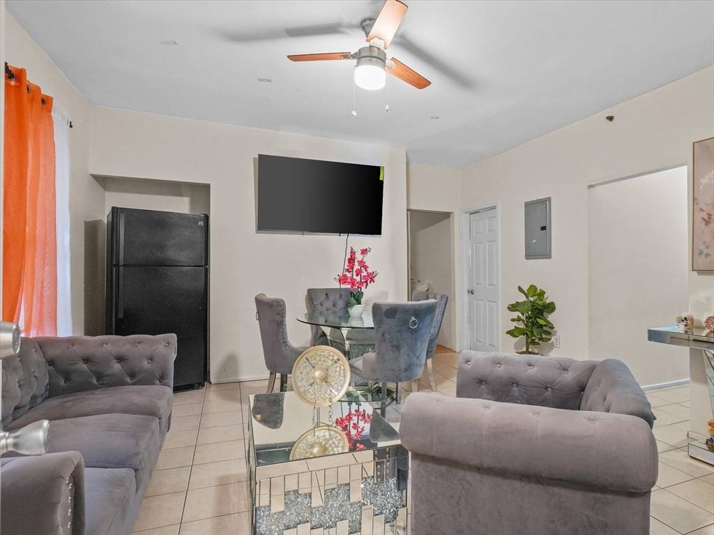 364 Lawrence Street Lawrence, MA 01841 - Photo 11 of 20 a living room with furniture and a flat screen tv