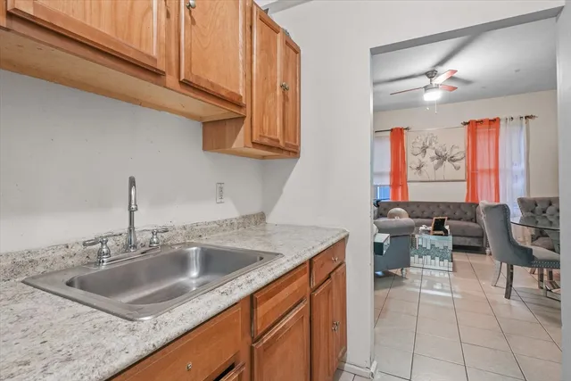 a kitchen with stainless steel appliances granite countertop a sink dishwasher and cabinets with wooden floor