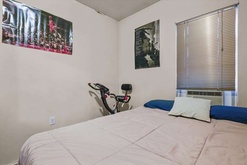 364 Lawrence Street Lawrence, MA 01841 - Photo 8 of 20 a bedroom with a large bed and a window
