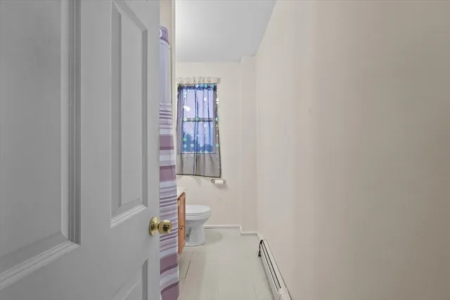a bathroom with a window and a shower