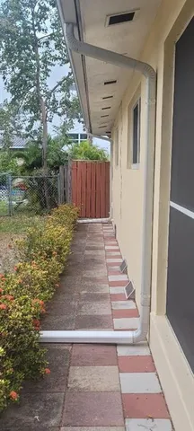 a view of backyard with wooden fence