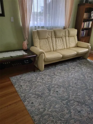 a living room with furniture and a rug