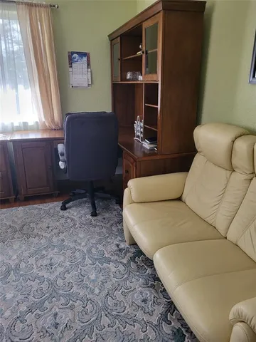 a living room with furniture a window and a potted plant