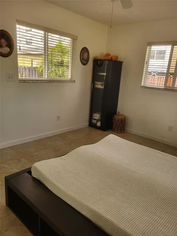 a bed sitting in a bedroom next to a window