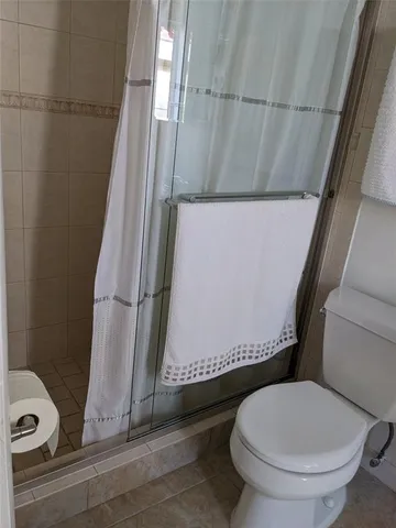 a bathroom with a toilet and a shower