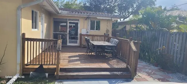 a view of a house with backyard porch and sitting area