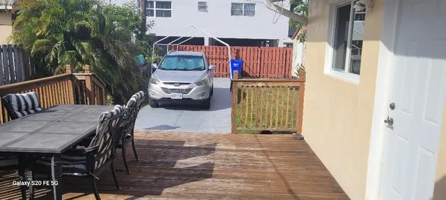 a pathway of a house with wooden fence