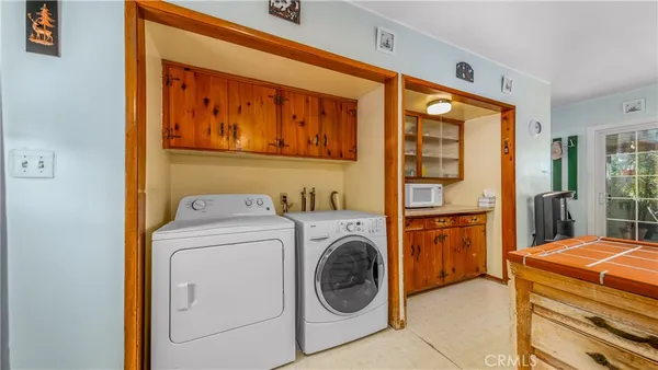 a kitchen with stainless steel appliances granite countertop a refrigerator dining table and chairs
