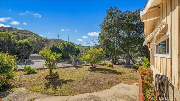 a view of a backyard with plants and a patio