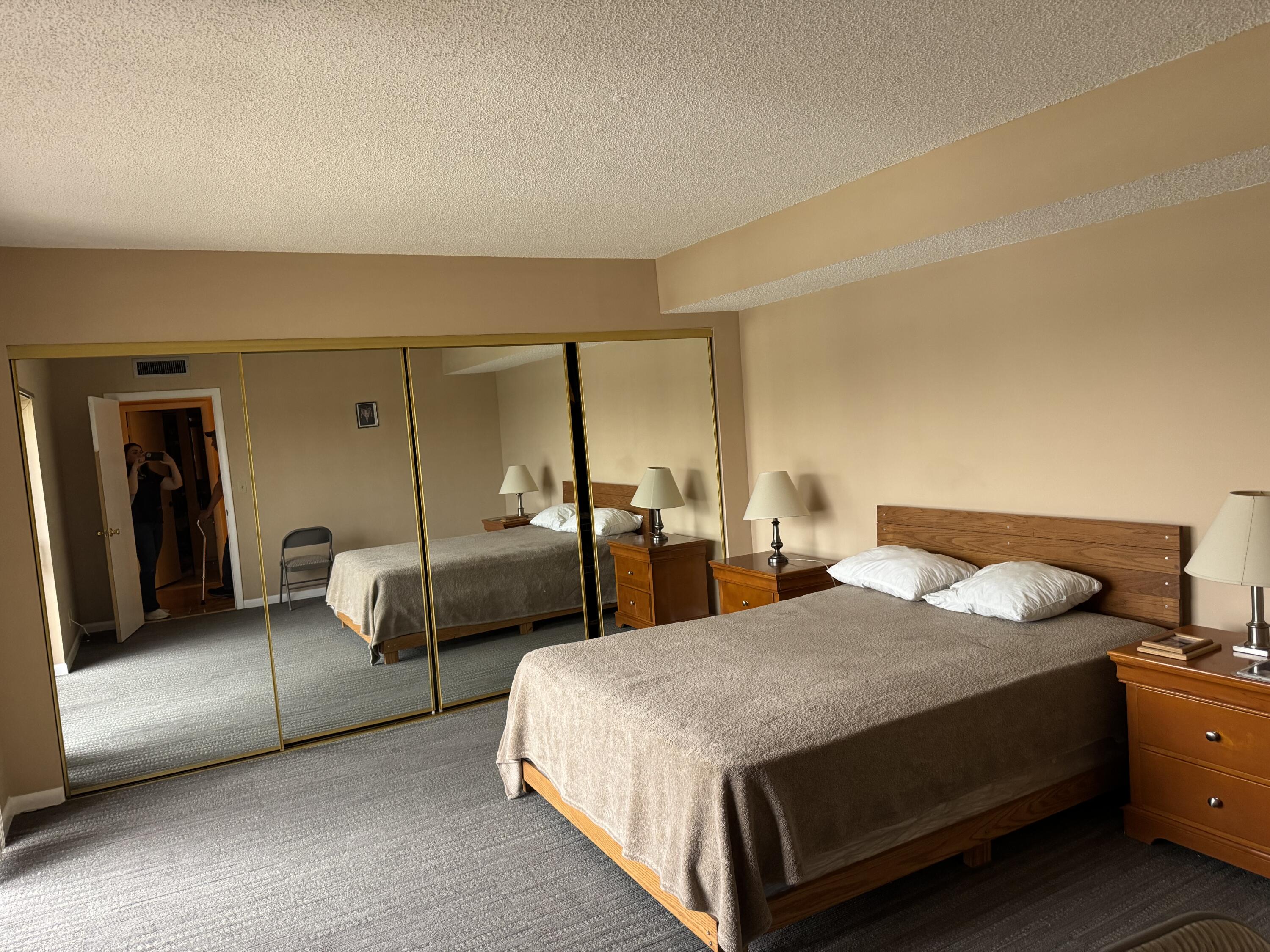 4101 Waterview Circle, Unit 41A Palm Springs, FL 33461 - Photo 12 of 26 a bedroom with two beds and painted walls