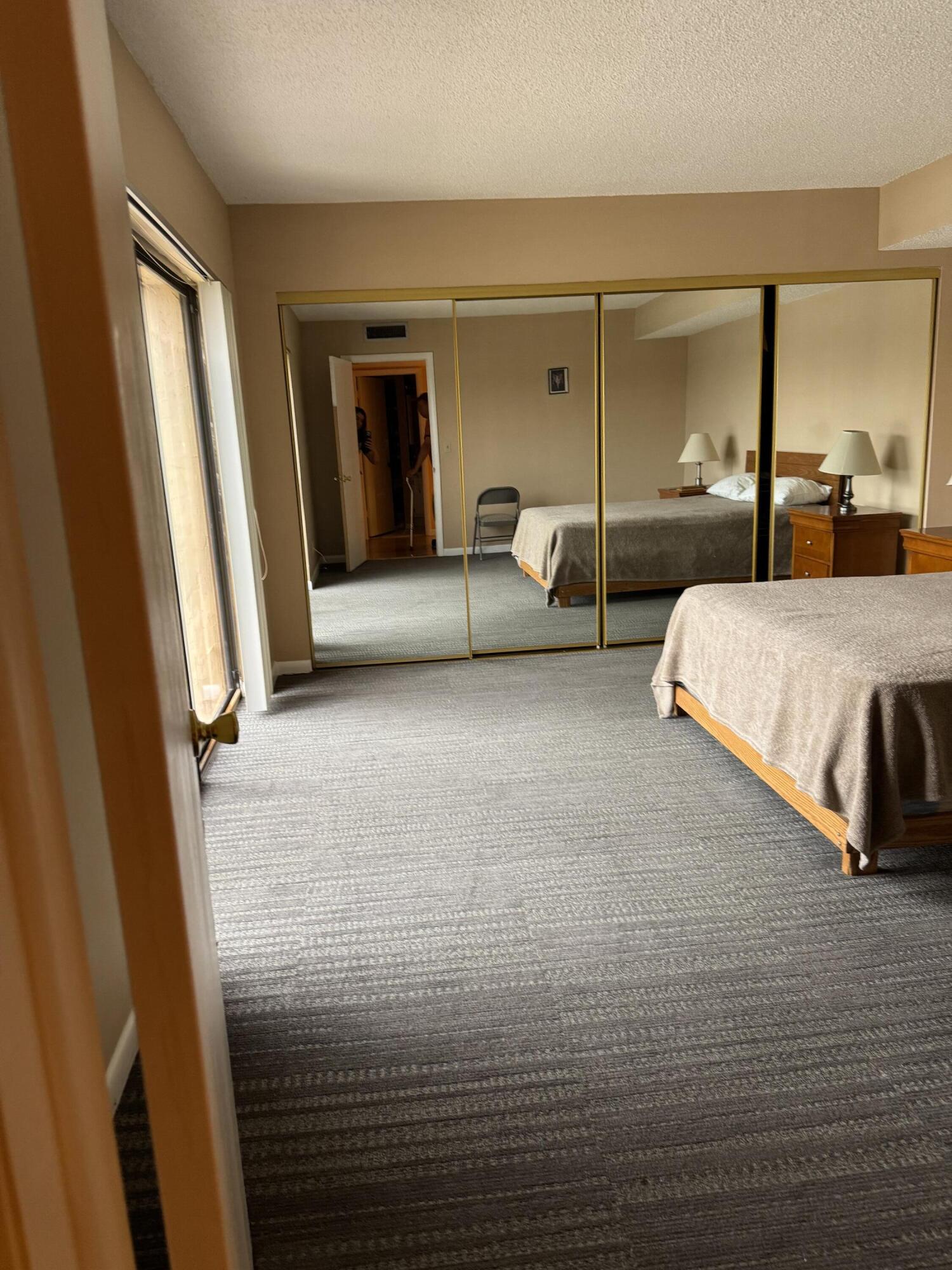 4101 Waterview Circle, Unit 41A Palm Springs, FL 33461 - Photo 13 of 26 a living room with furniture and a large mirror next to a window