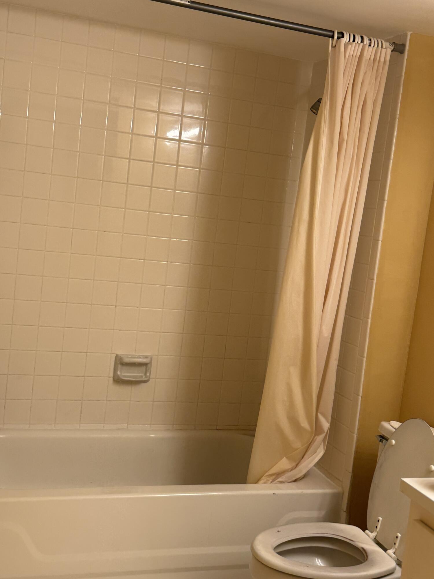 4101 Waterview Circle, Unit 41A Palm Springs, FL 33461 - Photo 15 of 26 a bathroom with a toilet and a bathtub