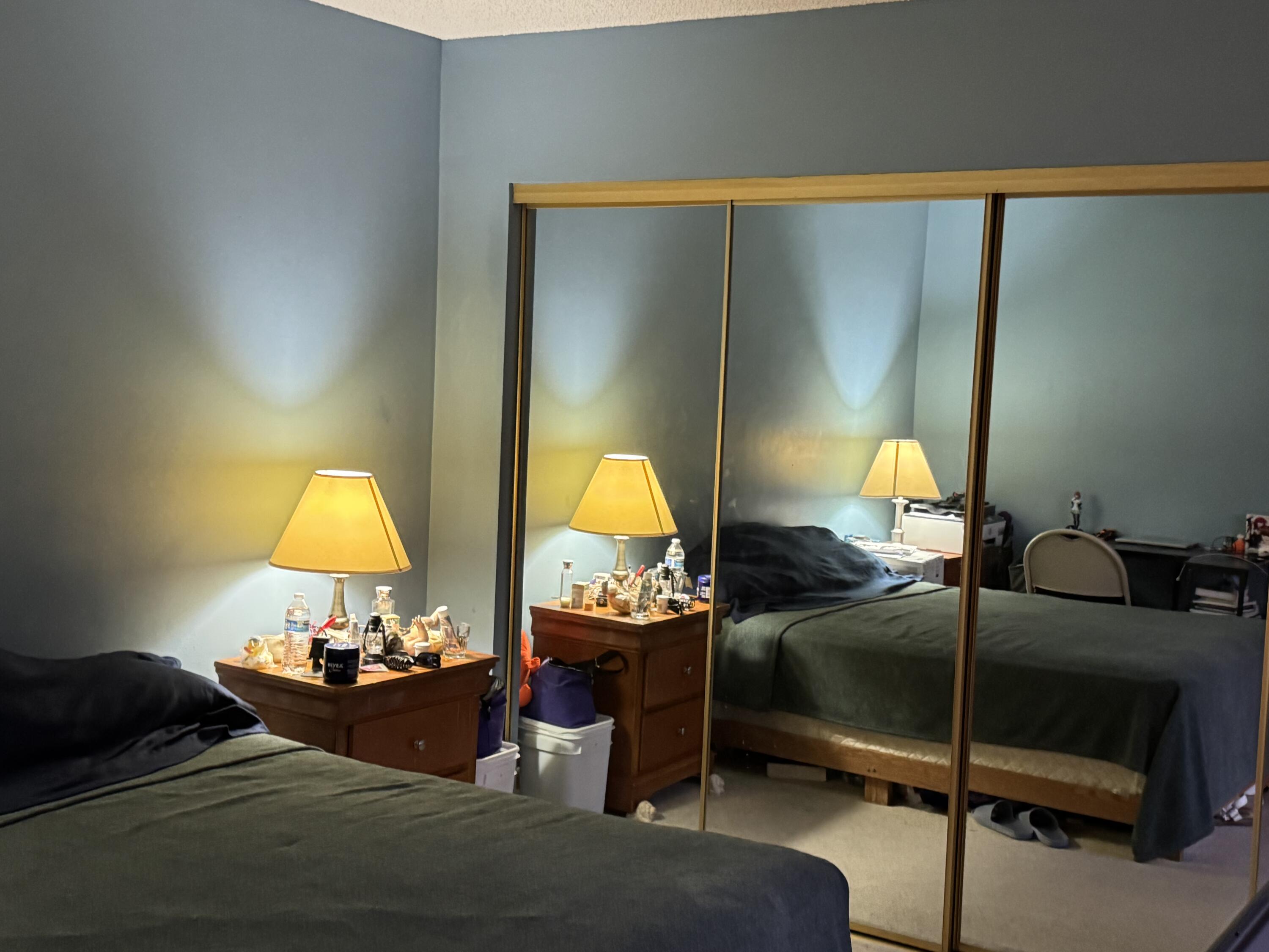 4101 Waterview Circle, Unit 41A Palm Springs, FL 33461 - Photo 16 of 26 a bedroom with a bed and lamp