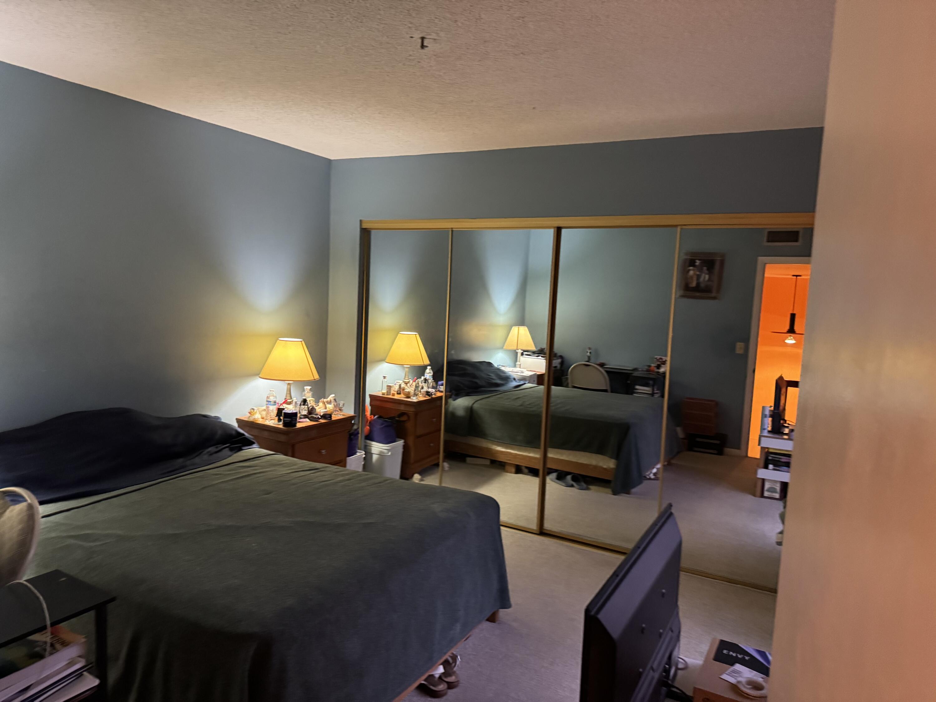 4101 Waterview Circle, Unit 41A Palm Springs, FL 33461 - Photo 17 of 26 a bedroom with furniture and a lamp