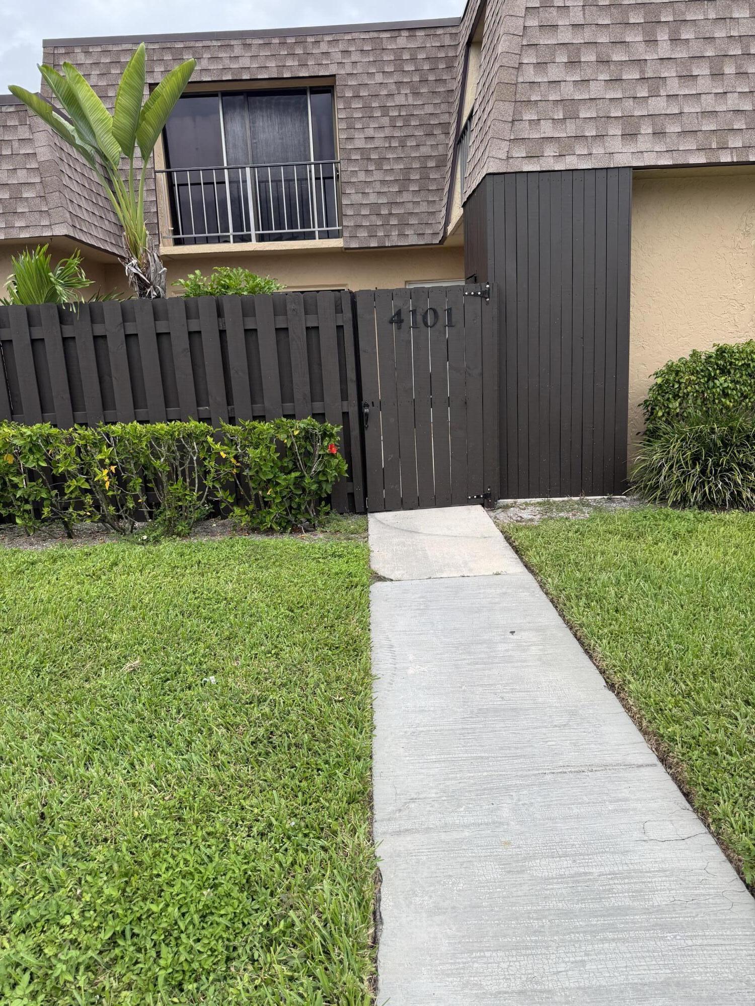 4101 Waterview Circle, Unit 41A Palm Springs, FL 33461 - Photo 3 of 26 a view of backyard with potted plants and wooden fence