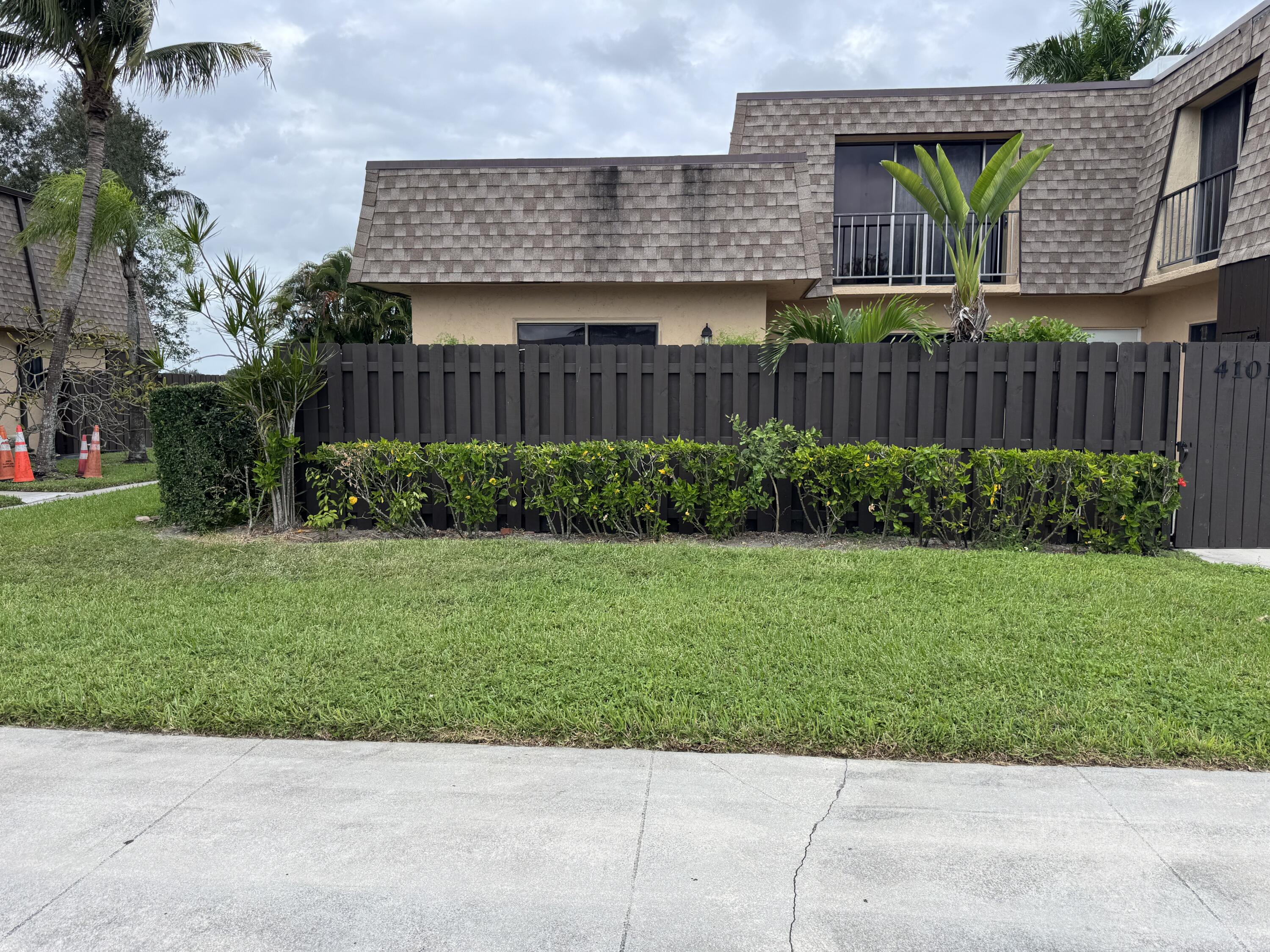 4101 Waterview Circle, Unit 41A Palm Springs, FL 33461 - Photo 4 of 26 a view of a backyard with plants and wooden fence