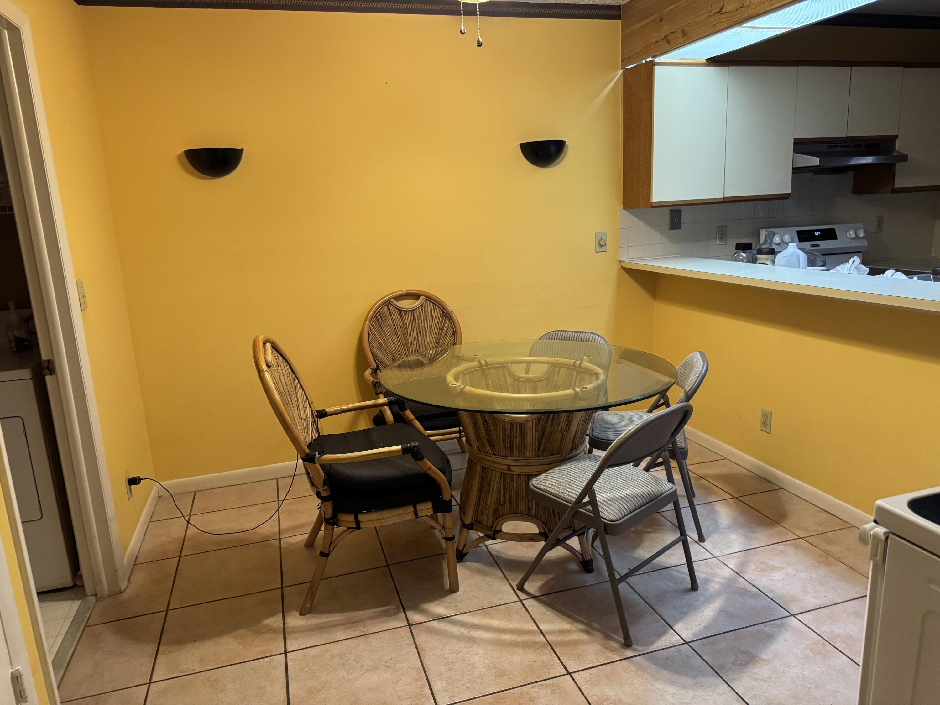 4101 Waterview Circle, Unit 41A Palm Springs, FL 33461 - Photo 10 of 26 a view of a dining room with furniture and a window