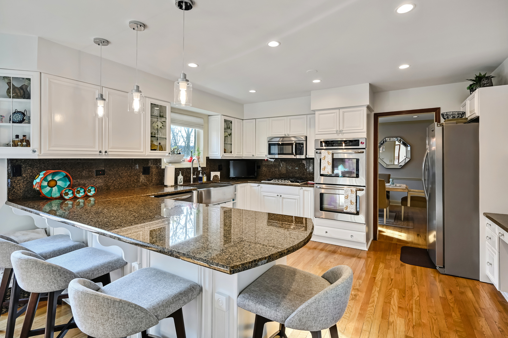 1435 Tomlin Drive Burr Ridge, IL 60527 - Photo 13 of 41 a kitchen with stainless steel appliances granite countertop a stove top oven a dining table and chairs