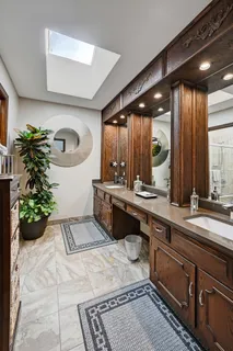 a spacious bathroom with a double vanity sink and a large mirror