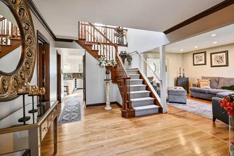 a view of entryway and hall with wooden floor