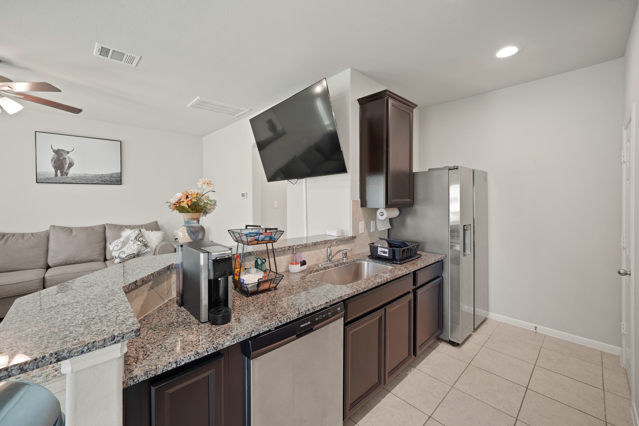 13303 Ardery Meadow Drive Houston, TX 77048 - Photo 13 of 33 a kitchen with granite countertop a sink and a stove top oven with wooden floor