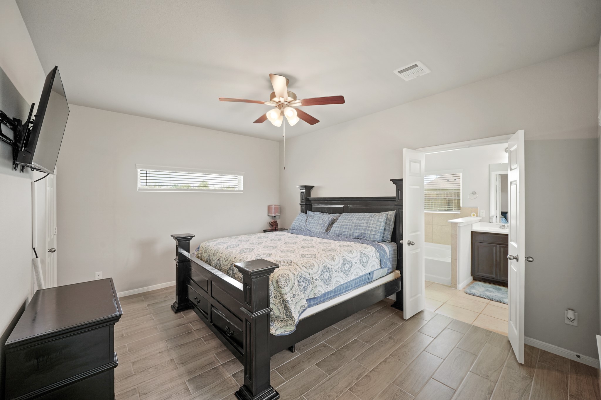 13303 Ardery Meadow Drive Houston, TX 77048 - Photo 16 of 33 a bedroom with a bed and a chandelier