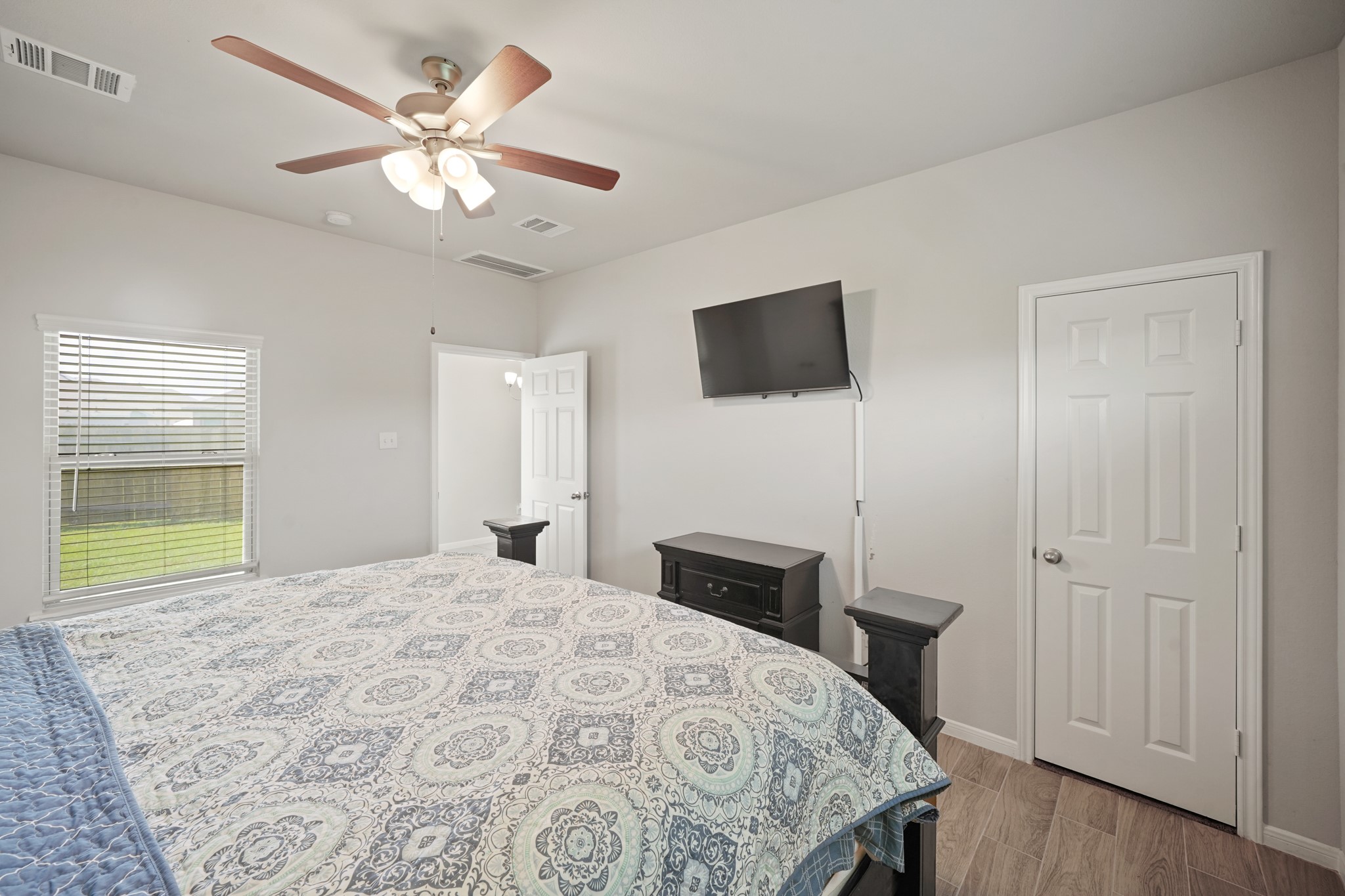13303 Ardery Meadow Drive Houston, TX 77048 - Photo 17 of 33 a bedroom with a bed and a flat screen tv