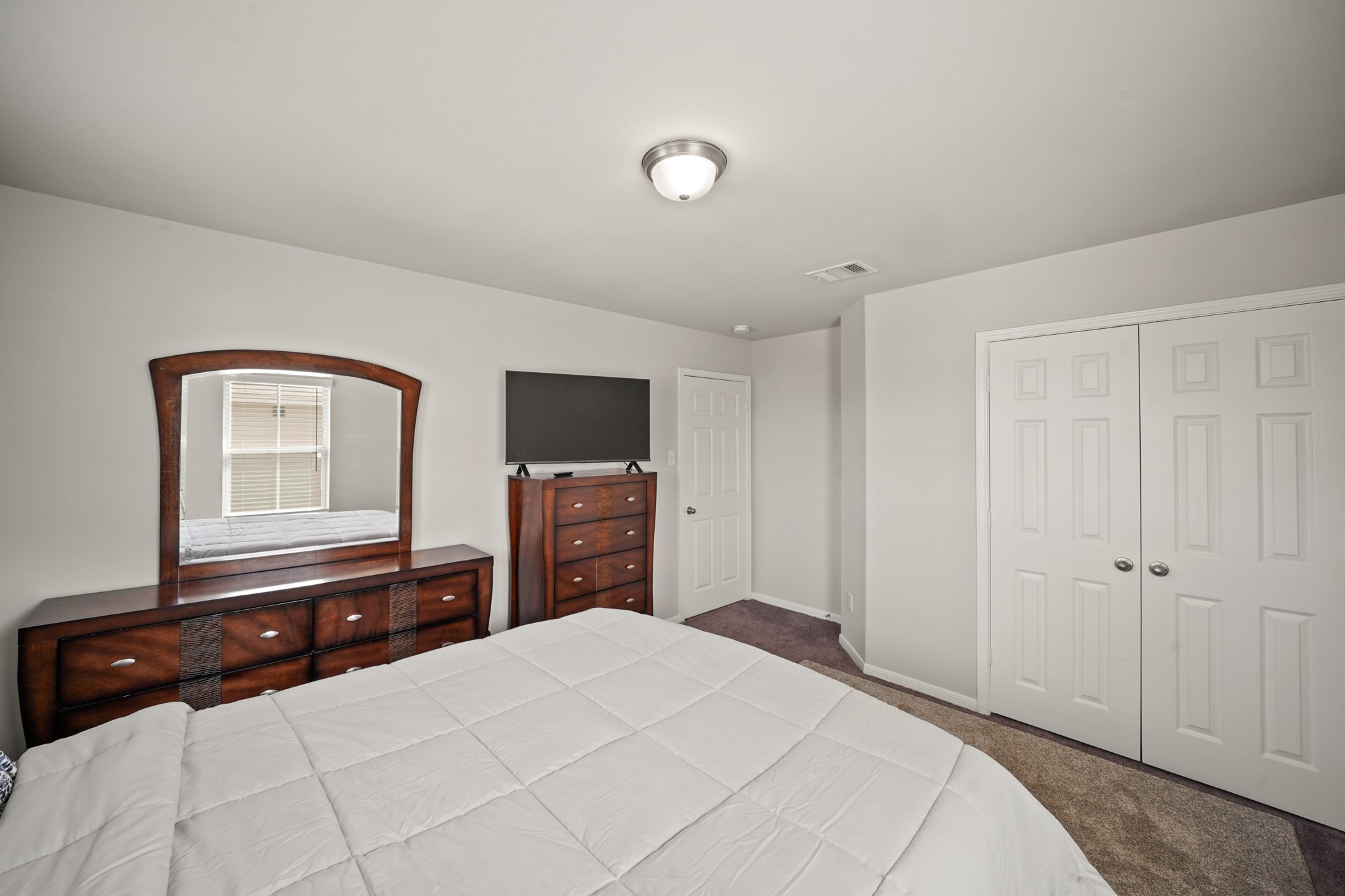 13303 Ardery Meadow Drive Houston, TX 77048 - Photo 28 of 33 a bedroom with a bed and a flat tv screen on dresser
