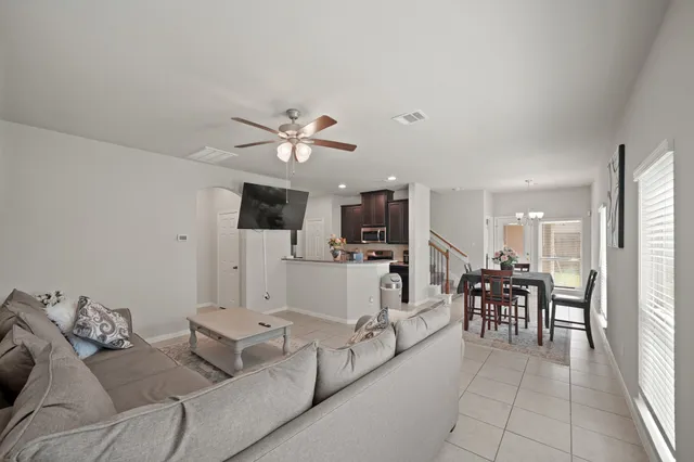 a living room with furniture and kitchen view