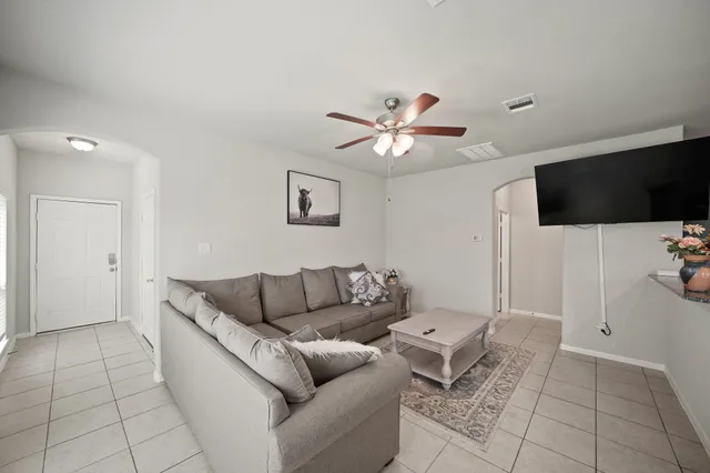 a living room with furniture and a flat screen tv