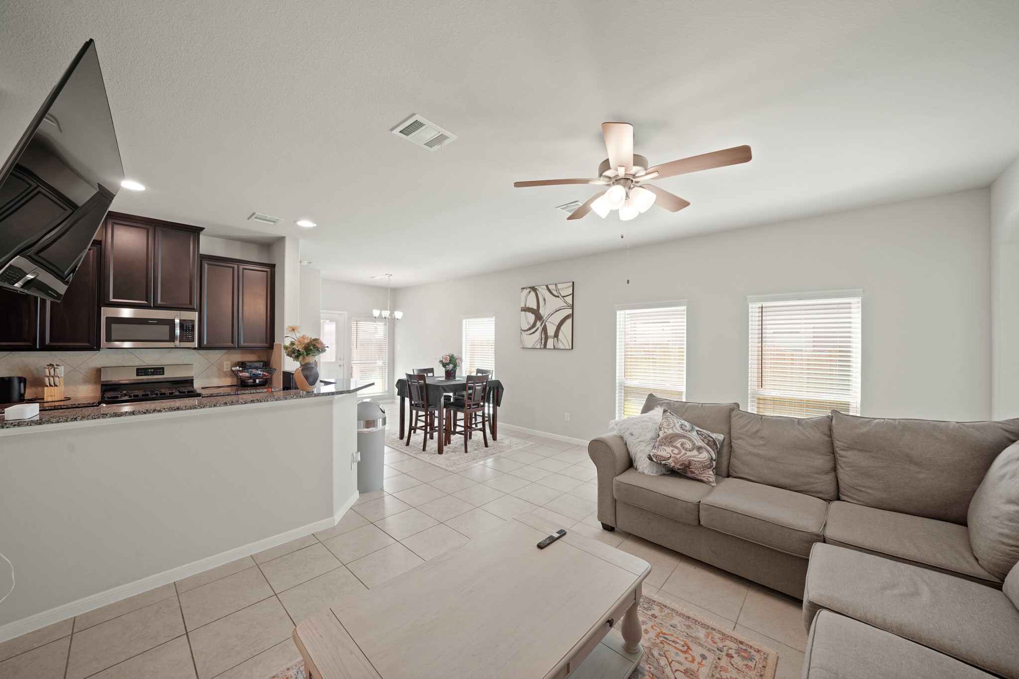 13303 Ardery Meadow Drive Houston, TX 77048 - Photo 8 of 33 a living room with furniture a dining table and kitchen view