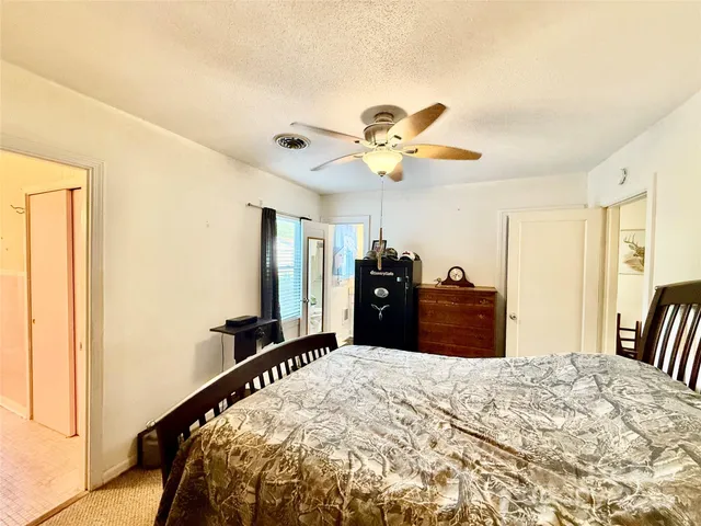 a bed room with a bed and a chandelier
