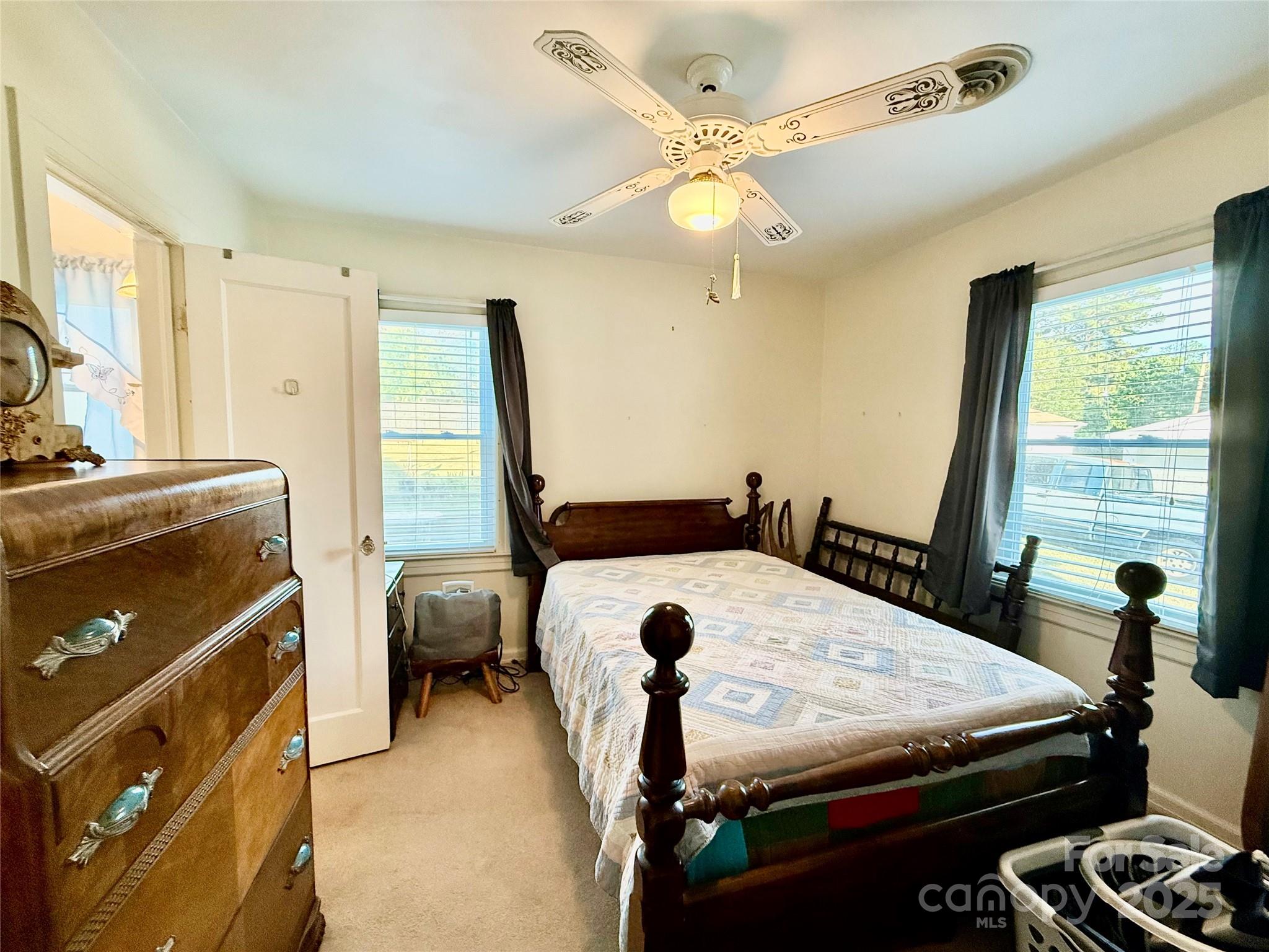 103 Magnolia Avenue Great Falls, SC 29055 - Photo 14 of 22 a bedroom with a bed and a chandelier