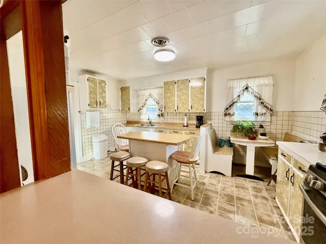 a living room with a sink and a stove top oven