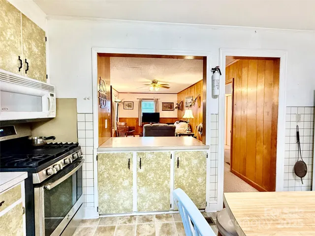 a kitchen with stainless steel appliances granite countertop a refrigerator and a stove