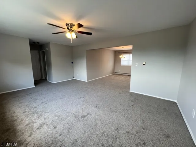 a view of a livingroom with a ceiling fan and window