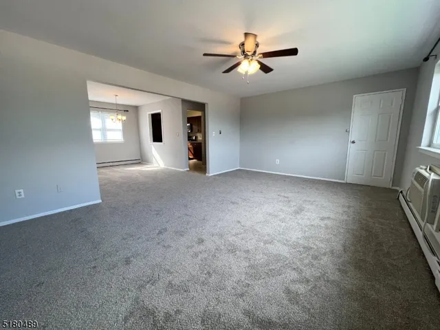 a view of a livingroom with a ceiling fan and window