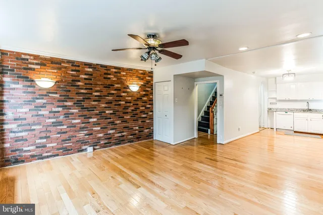 a view of empty room with wooden floor and cabinet